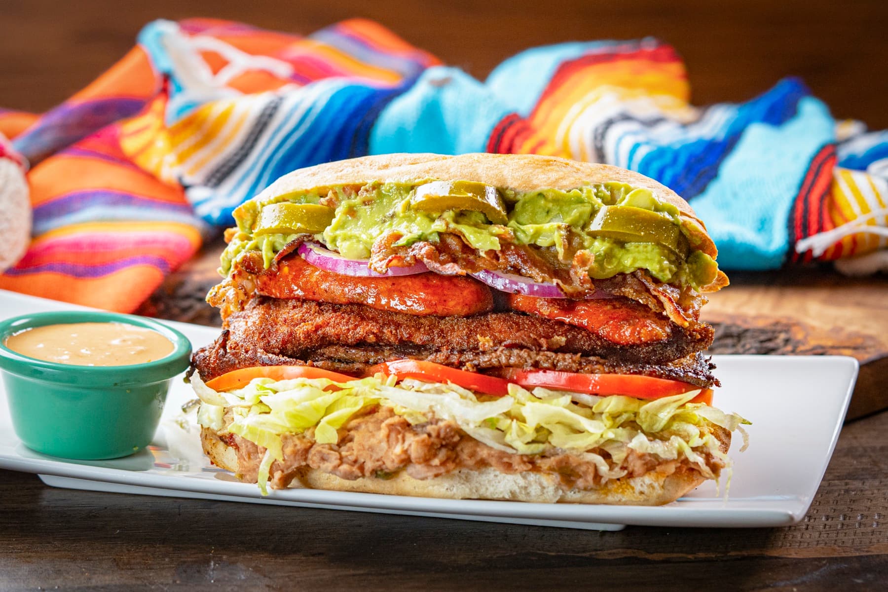 A signature Rinconcito Domex sandwich served with sauce